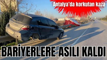 Antalya'da korkutan kaza! Bariyerlere asılı kaldı